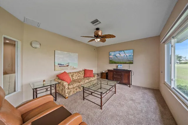 a living room with furniture a window and a chandelier