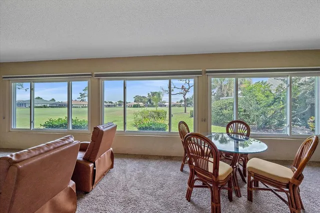 a dining room with furniture water view and a flat screen tv