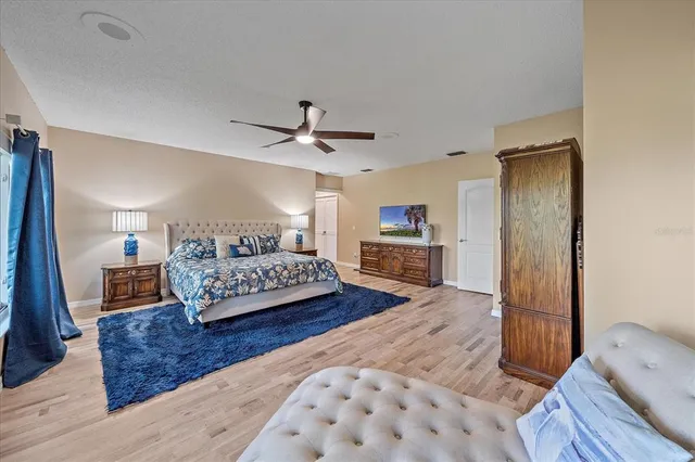 a bedroom with a bed a couch and dresser