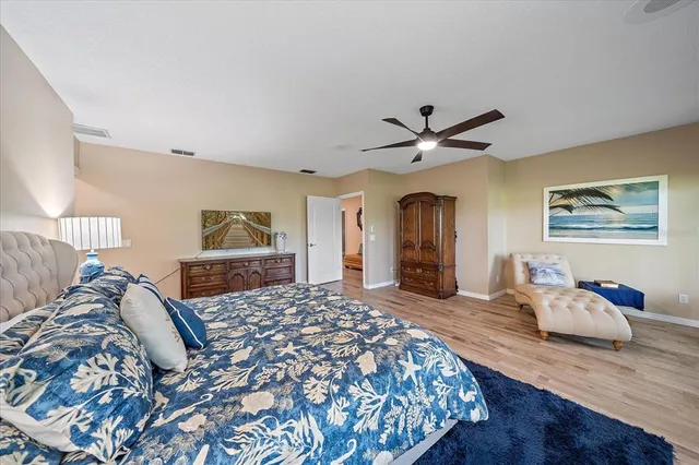 a bedroom with a large bed and a chandelier