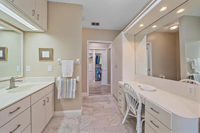 a spacious bathroom with a double vanity sink and a mirror
