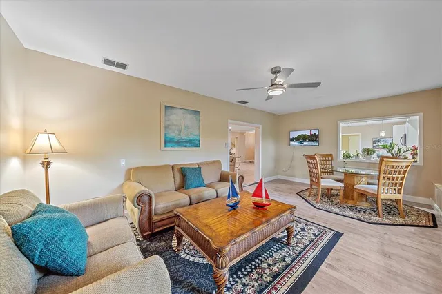 a living room with furniture a rug and a chandelier