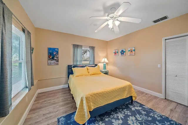 a bed sitting in a bedroom next to a window