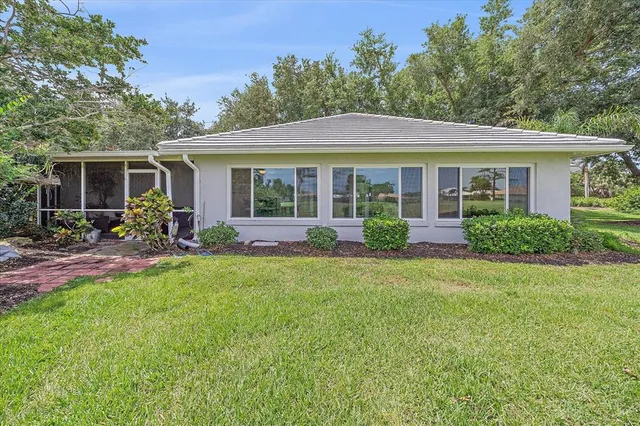 a view of a house with backyard sitting area and garden