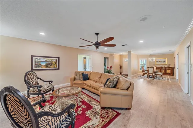 a living room with furniture and a ceiling fan