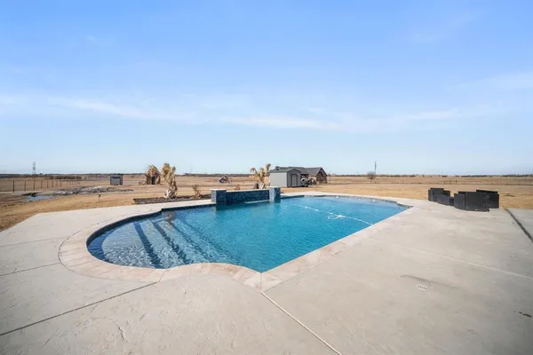a view of a swimming pool and a yard