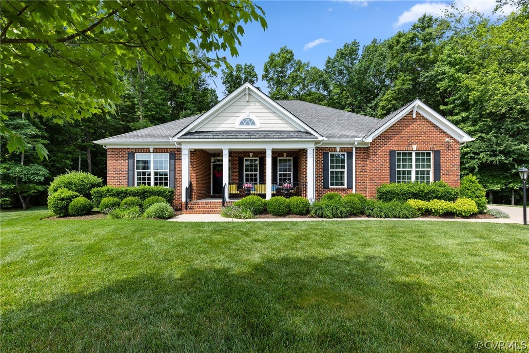 168 Button Bush Road Richmond, VA 23238 - Photo 42 of 42 a front view of a house with a yard and trees