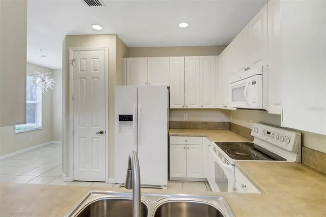 a kitchen with a sink stove and refrigerator