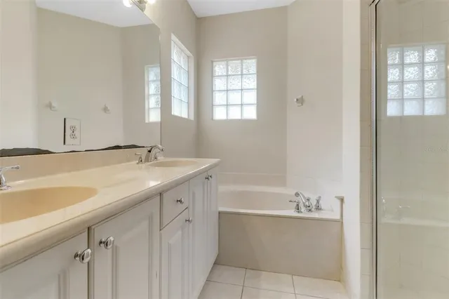a bathroom with a tub sink and mirror