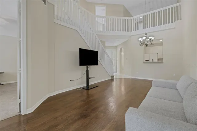 a living room with furniture and a chandelier