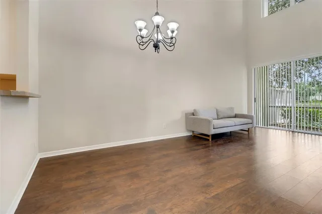 a living room with furniture and a floor to ceiling window