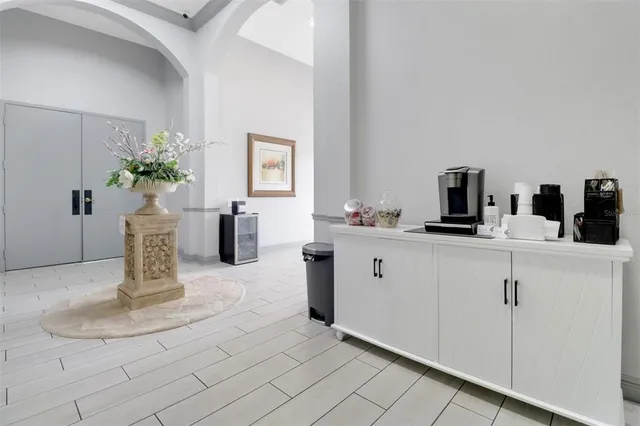 a kitchen with sink and mirror