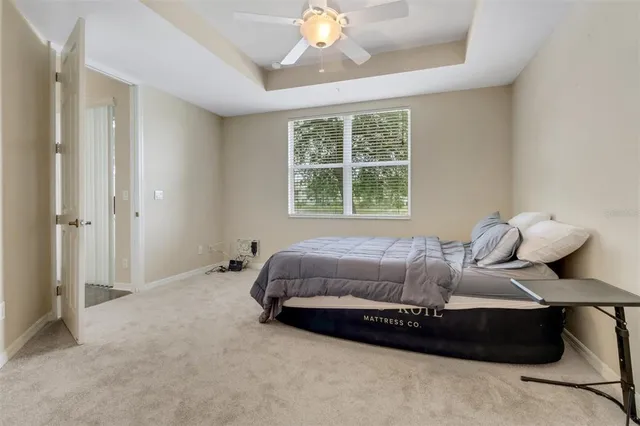 a spacious bedroom with a bed and window