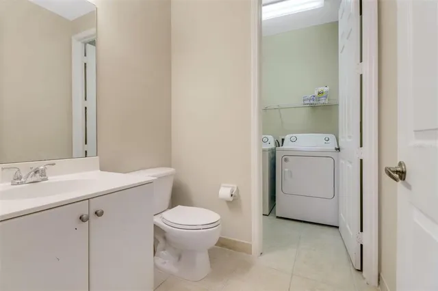 a white toilet sitting next to a bathroom sink