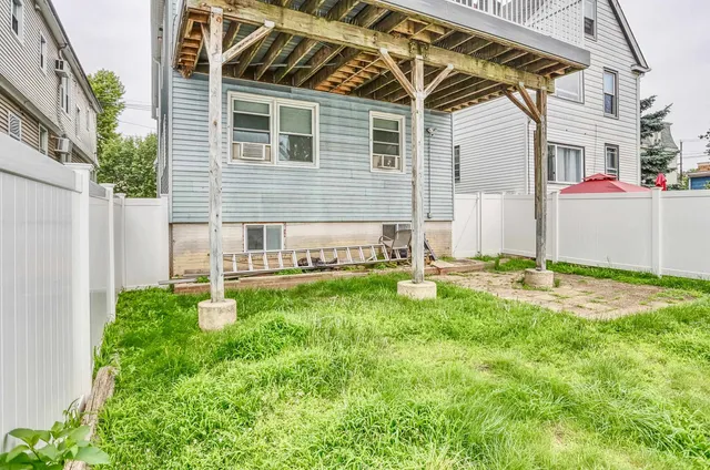 a backyard of a house with table and chairs