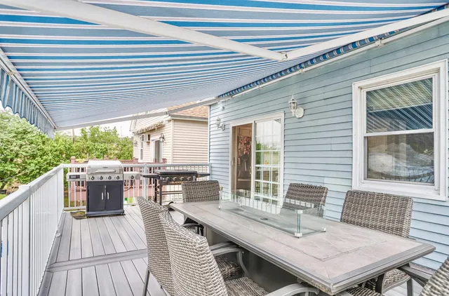 a balcony with furniture and wooden floor