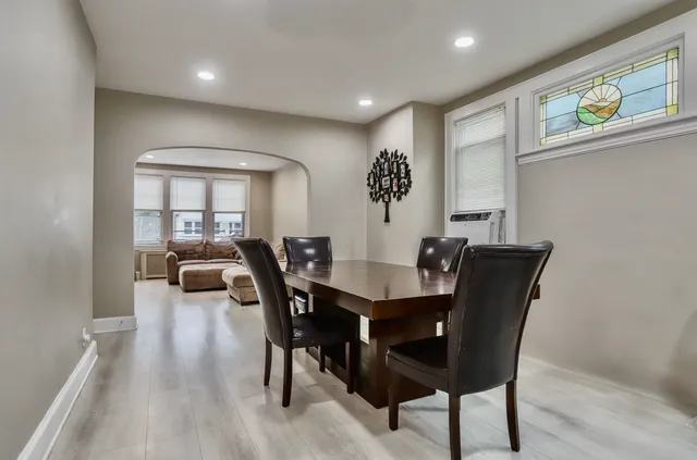 a view of a a dining room with furniture window and wooden floor
