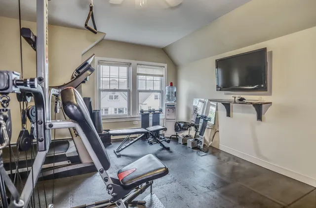 a living room with furniture a flat screen tv and a window
