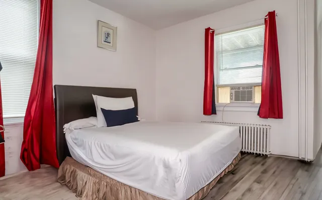 a bedroom with a bed and a window