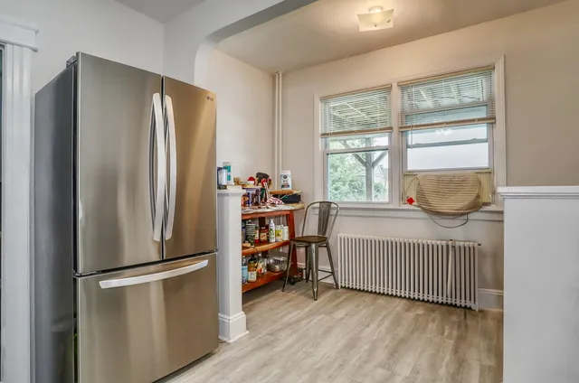 a room with baby crib and a window