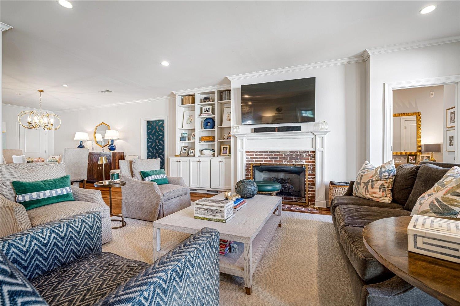 3682 Oakley Avenue Memphis, TN 38111 - Photo 10 of 34 a living room with furniture a flat screen tv and a fireplace