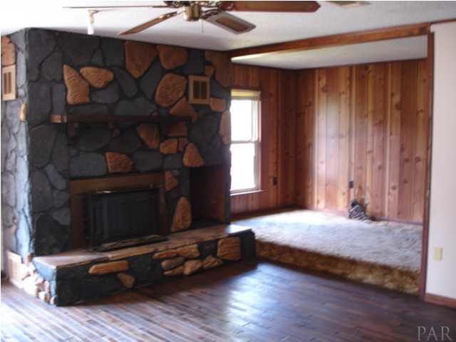 1085 Tate Road Cantonment, FL 32533 - Photo 3 of 19 Stone veneer fireplace with inside log box and fireplace insert to provide extra warmth during our cold Winter nights.