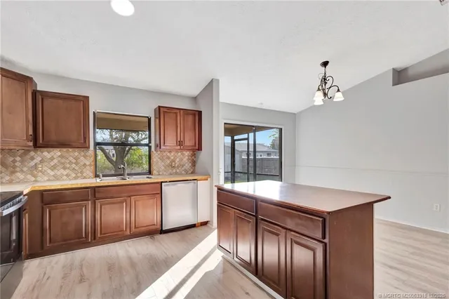 a kitchen with granite countertop a stove and white cabinets
