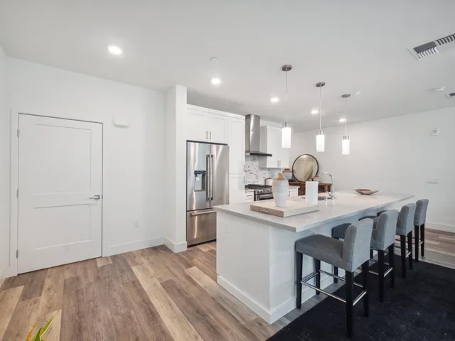a kitchen with kitchen island a sink appliances and cabinets