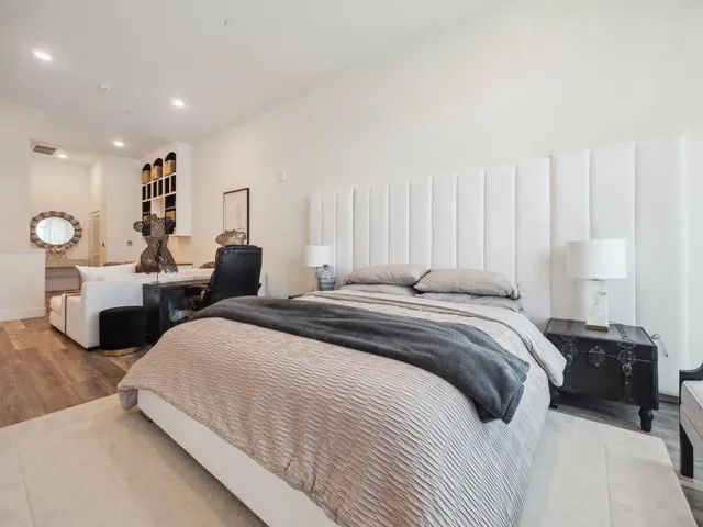 a bedroom with two beds and a large window