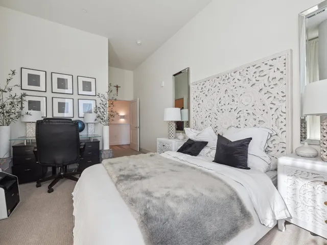 a bedroom with a bed dresser and a chair