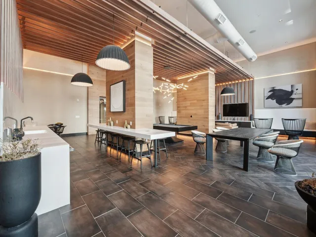 a living room with fireplace furniture and a large window