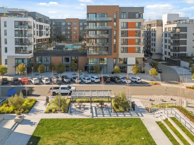 a large building with swimming pool in front of it