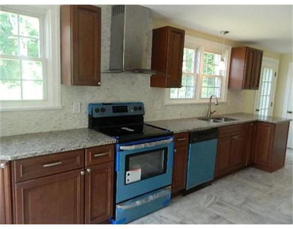 37 Arnold Road Sturbridge, MA 01518 - Photo 4 of 21 a kitchen with granite countertop a sink and a stove