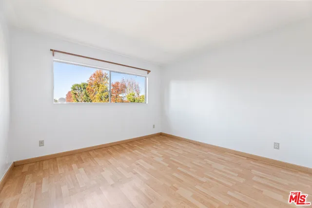 an empty room with a painting on the wall