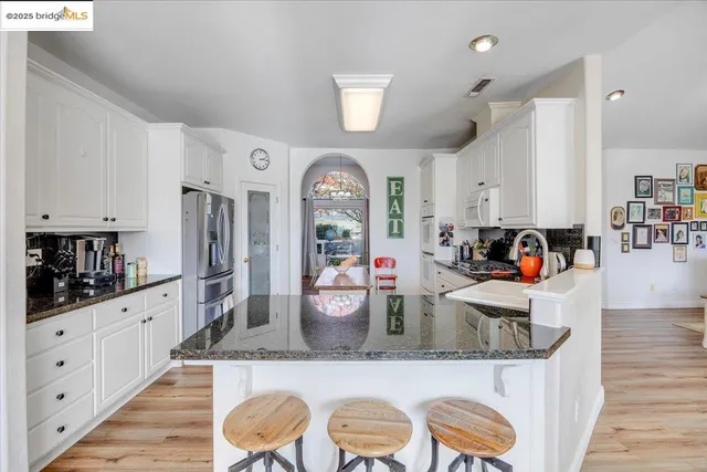 a dining room with furniture and wooden floor