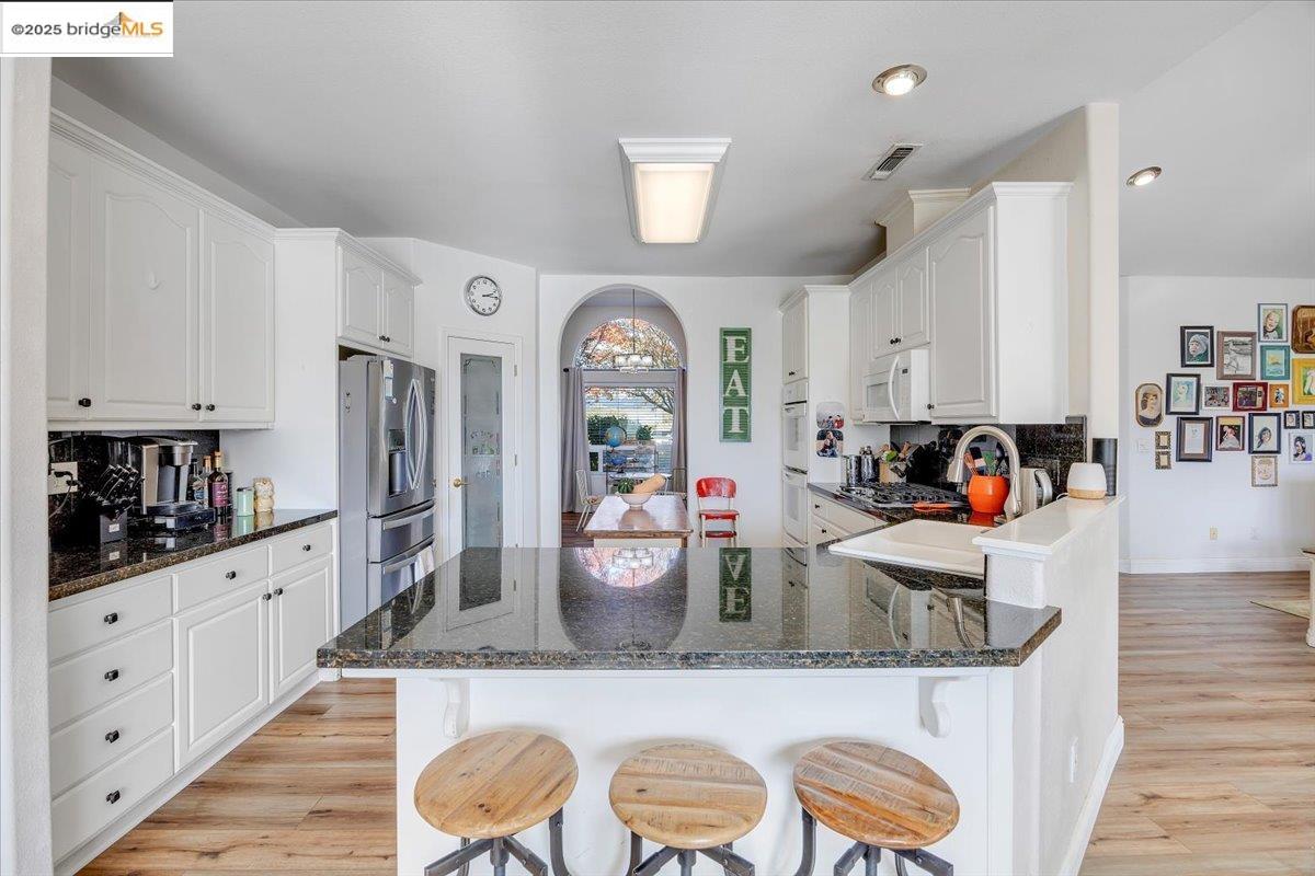 10200 Bell Mooney Road Jamestown, CA 95327 - Photo 17 of 60 a kitchen with granite countertop a white cabinets and window