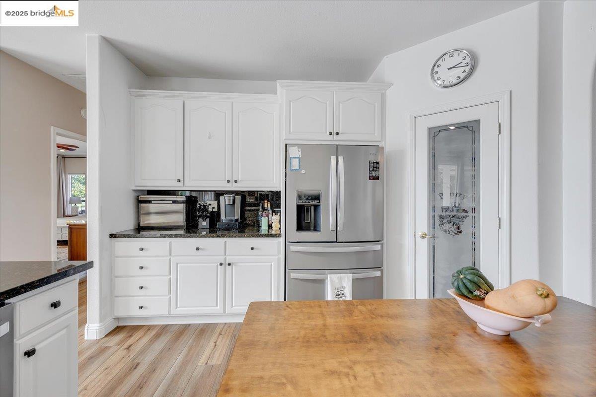 10200 Bell Mooney Road Jamestown, CA 95327 - Photo 19 of 60 a large white kitchen with granite countertop a stove a sink and dishwasher with white cabinets