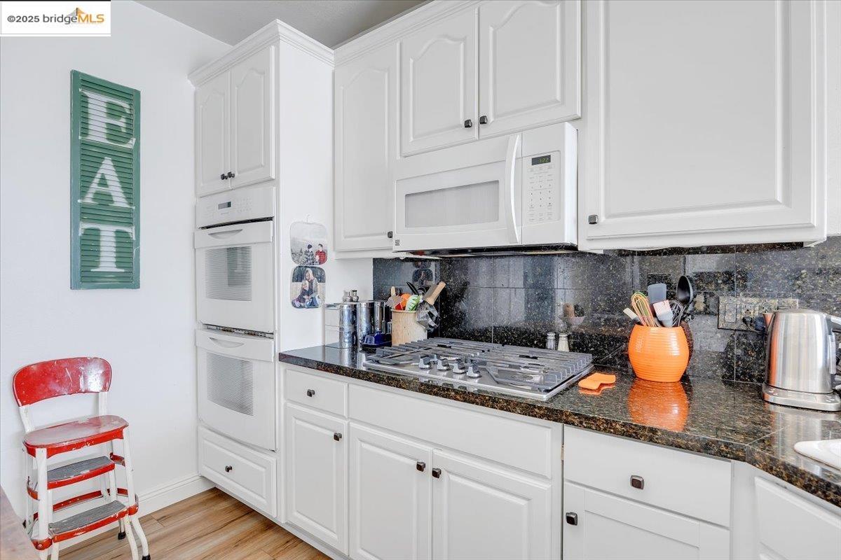 10200 Bell Mooney Road Jamestown, CA 95327 - Photo 20 of 60 a kitchen with white cabinets and sink