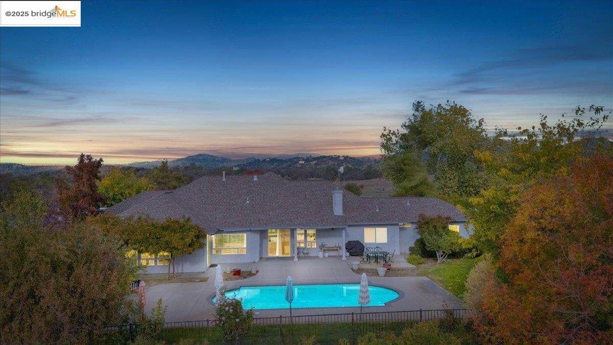10200 Bell Mooney Road Jamestown, CA 95327 - Photo 2 of 60 Back of property featuring a patio area and a chimney