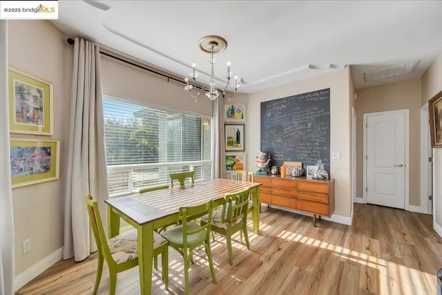 a bedroom with a bed and dresser with mirror