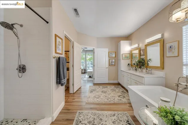 a view of a hallway with wooden floor and furniture