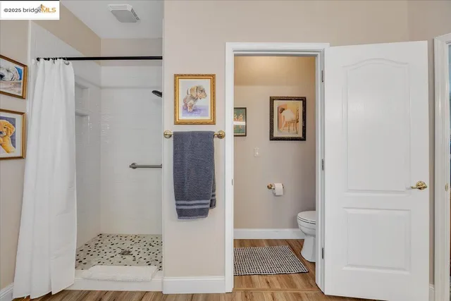 a bedroom with a bed a couch and a window