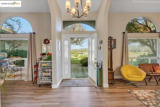 a view of an entryway with wooden floor and a livingroom