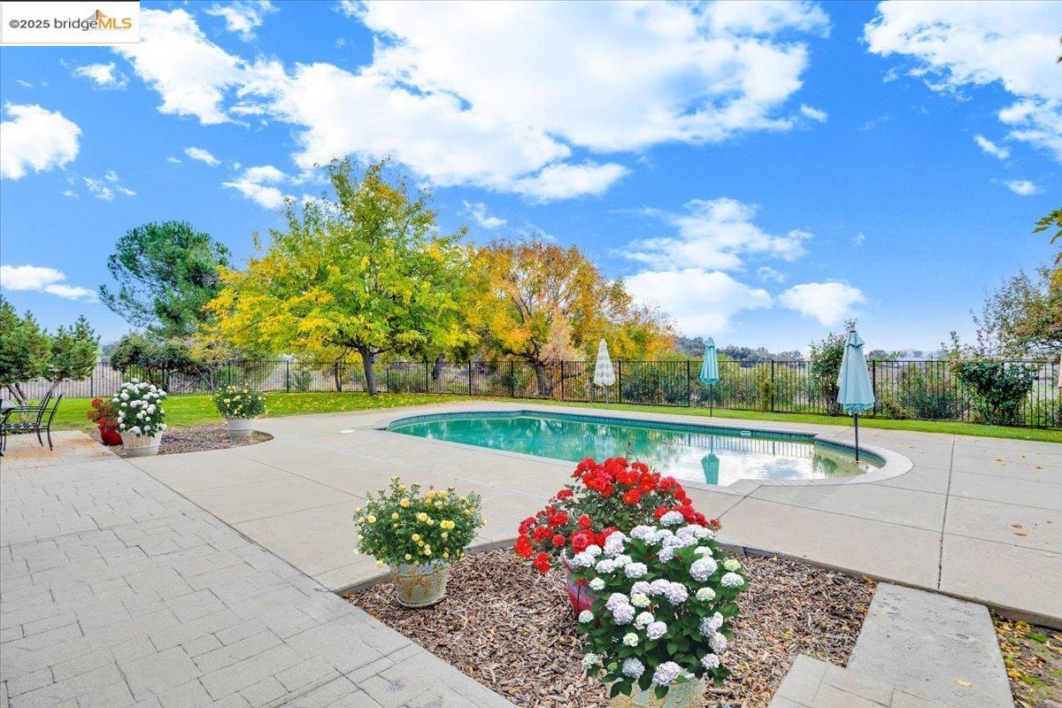 10200 Bell Mooney Road Jamestown, CA 95327 - Photo 42 of 60 View of swimming pool featuring a patio area and a fenced backyard
