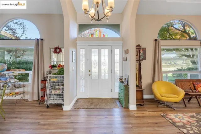 a view of a livingroom with wooden floor and furniture