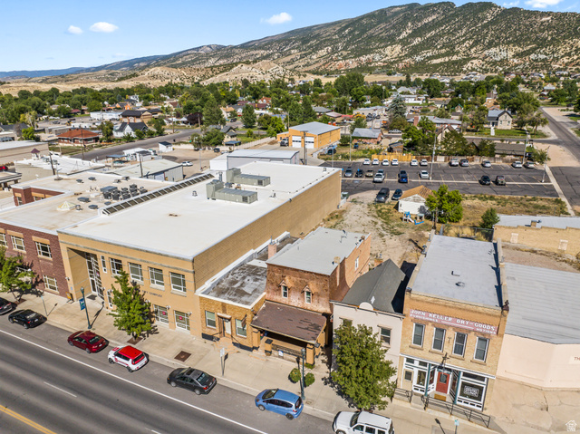 69 South Main Street Manti, UT 84642 - Photo 8 of 44 Commercial properties featuring brick and stucco facades, multiple storefronts, and ample street-side parking
