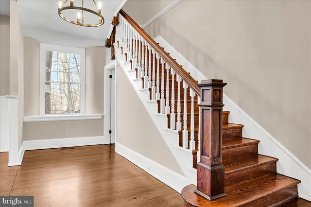 a view of entryway with wooden floor and stairs