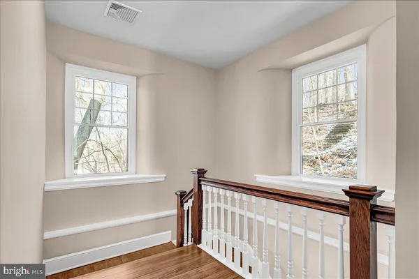 a view of a room with a window and a wooden floor