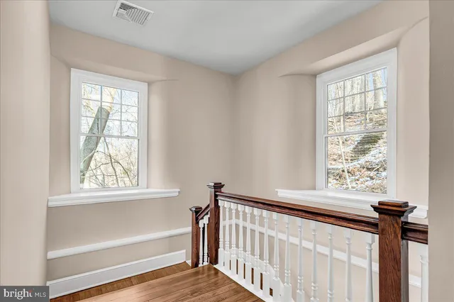 a view of a room with a window and a wooden floor