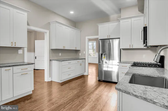 a kitchen with stainless steel appliances granite countertop a refrigerator stove and oven